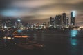 Yacht or boat next to Miami downtown. Beautiful colorful city of Miami Florida skyline and bay with night clouds. Royalty Free Stock Photo