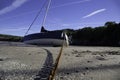 Yacht boat on a sandy beach tethered with a rusty chain