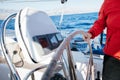 Yacht captain hand on yacht steering wheel