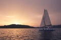 Yacht - Catamaran in the ocean. Sailing at sunset