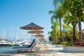 Yacht club and resort, sun loungers to relax near the water Royalty Free Stock Photo