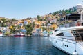 Yacht and colorful neoclassical houses in harbor town of Symi Symi Island, Greece