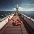 Yacht deck with lifebuoy sail, ropes and wheel. AI generative. Royalty Free Stock Photo