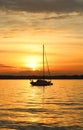 Yacht drifting on the lake during beautiful summer sunset. Royalty Free Stock Photo