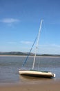 Yacht edge of tide River Kent estuary, Arnside, UK