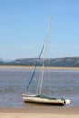 Yacht edge of tide River Kent estuary, Arnside, UK