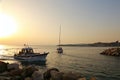 Yacht floats in the sea from marina at sunset