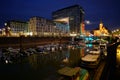 Yacht harbor surrounded by buildings and lights at night in Cologne, Germany Royalty Free Stock Photo