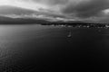 Yacht heading ashore. Dramatic black and white photo.