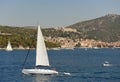 Yacht in Hvar harbour with Hvar old town at the background, Croatia