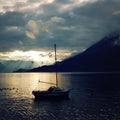 Yacht on Lake Como at the sunset. Pleasure boat. Royalty Free Stock Photo