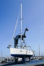 The yacht lifted ashore by a sailboat lift for the maintenance of the underwater part of the hull