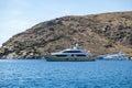 Yacht, luxury motorboat moored at a secluded beach, Kythnos island Greece. Summer vacation Royalty Free Stock Photo