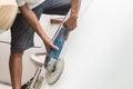 Yacht maintenance. A man polishing side of the white boat in the Royalty Free Stock Photo