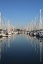 Yacht marina on a calm day with blue sky and reflective water