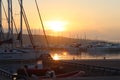 Yacht in the marina during the morning dawn sailing past the moored sailing yachts. Marine life style. Romantic and extreme rest o