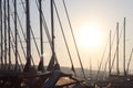 Yacht in the marina during the morning dawn sailing past the moored sailing yachts. Marine life style. Romantic and extreme rest o