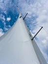 Yacht mast with the sail on the blue sky Royalty Free Stock Photo