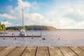 Yacht near the wooden mini pier on Lake in Finland. On a summer evening