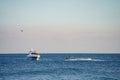 Yacht in the ocean with tourists on waverunner approaching