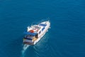 Yacht with passengers sun loungers at the stern floating on the water surface in summer