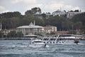 Yacht passes in front of Topkapi Palace in Istanbul