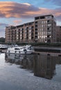 Yacht at the pier. City landscape. Sunset on the embankment after rain