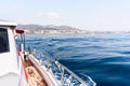 Yacht or private luxury boat ride. Sailing in the sea or ocean with motorboat or sailboat. View from the deck to the coast. Royalty Free Stock Photo