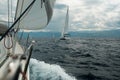 Yacht racing at sea in cloudy weather.