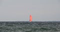 Yacht with red balloon sail seen on the ocean with a storm coming up Royalty Free Stock Photo