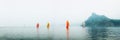 Yacht regatta with an orange sail in a foggy morning floats on the sea Royalty Free Stock Photo