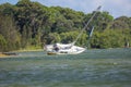 Yacht run aground in bay waiting for high tide Royalty Free Stock Photo