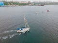 Yacht sailing against sunset. Holiday lifestyle landscape with skyline sailboat and sunset silhouette. Yachting tourism