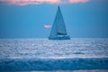 Yacht sailing against sunset. Landscape with skyline sailboat and sunset silhouette. Yachting tourism. Romantic trip on