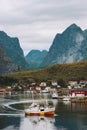 Yacht sailing in fjord Lofoten islands Reine village in Norway mountains landscape