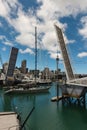 Yacht sailing through open bridge in Auckland marina Royalty Free Stock Photo