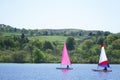 Yacht sailing in summer lake colourful sail blown in wind