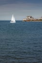 Yacht sailing towards sunset in blue background, Royalty Free Stock Photo