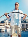 Yacht, sailing and travel with a mature man steering a boat on the ocean or sea during summer vacation or holiday. Water Royalty Free Stock Photo