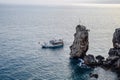 The yacht sails along the rocky coast, an excursion the coast of Antalya Royalty Free Stock Photo
