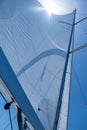 Yacht sails on clear blue sky background. Sailing with the wind at open sea ocean, summer holidays Royalty Free Stock Photo