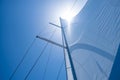 Yacht sails on clear blue sky background. Sailing with the wind at open sea ocean, summer holidays Royalty Free Stock Photo