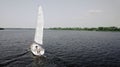 The yacht sails on the Dnipro river. Drone flies around the sailing yacht