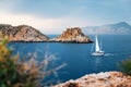 Yacht sails at Mediterranean sea between cliffs, Mallorca Royalty Free Stock Photo