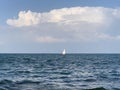 Yacht at sea against the blue sky. Clear weather, beautiful contrast against the background of clear sky and water. Boat in the Royalty Free Stock Photo