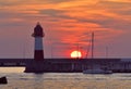 Yacht at the sea lighthouse at sunset Royalty Free Stock Photo