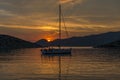 Yacht on sea and orange clouds at sunset