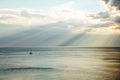 Yacht in the sea rays from clouds landscape Royalty Free Stock Photo