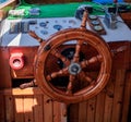 Yacht steering wheel and control panel. Ready to sea travel. Wooden deck interior of sailing boat. Ship on pier. Good Royalty Free Stock Photo