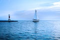 Yacht at the sunset in the blue sea. White sail against the back Royalty Free Stock Photo